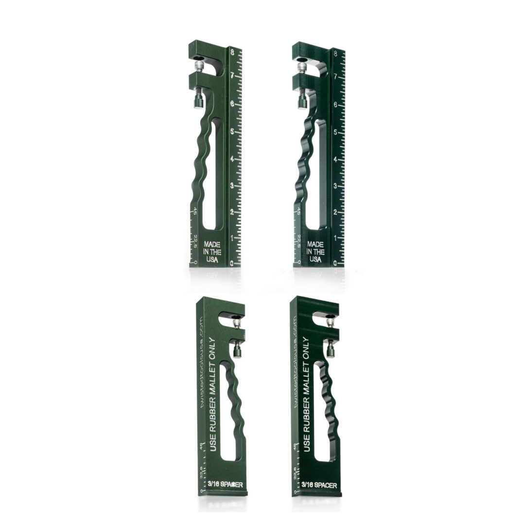 A set of four green metal rulers.